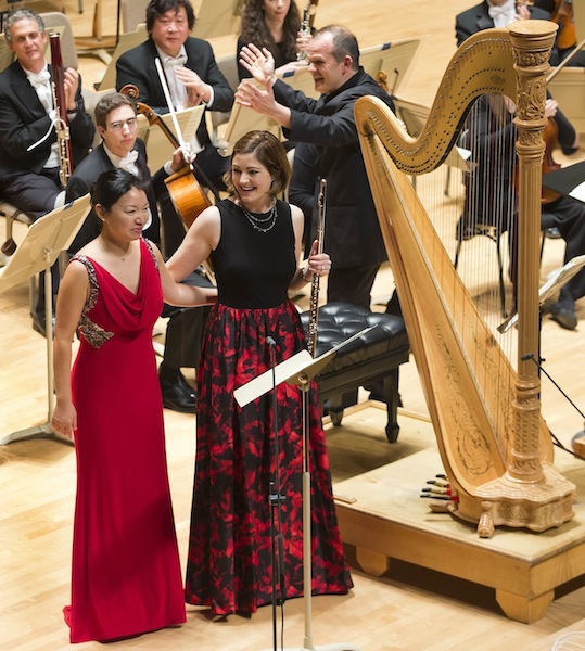Elizabeth Rowe and Jessica Zhou take a bow following their performance of Mozart's Concerto for Flute and Harp with François-Xavier Roth and the Boston Symphony Orchestra Thursday night. Photo: Winslow Townson